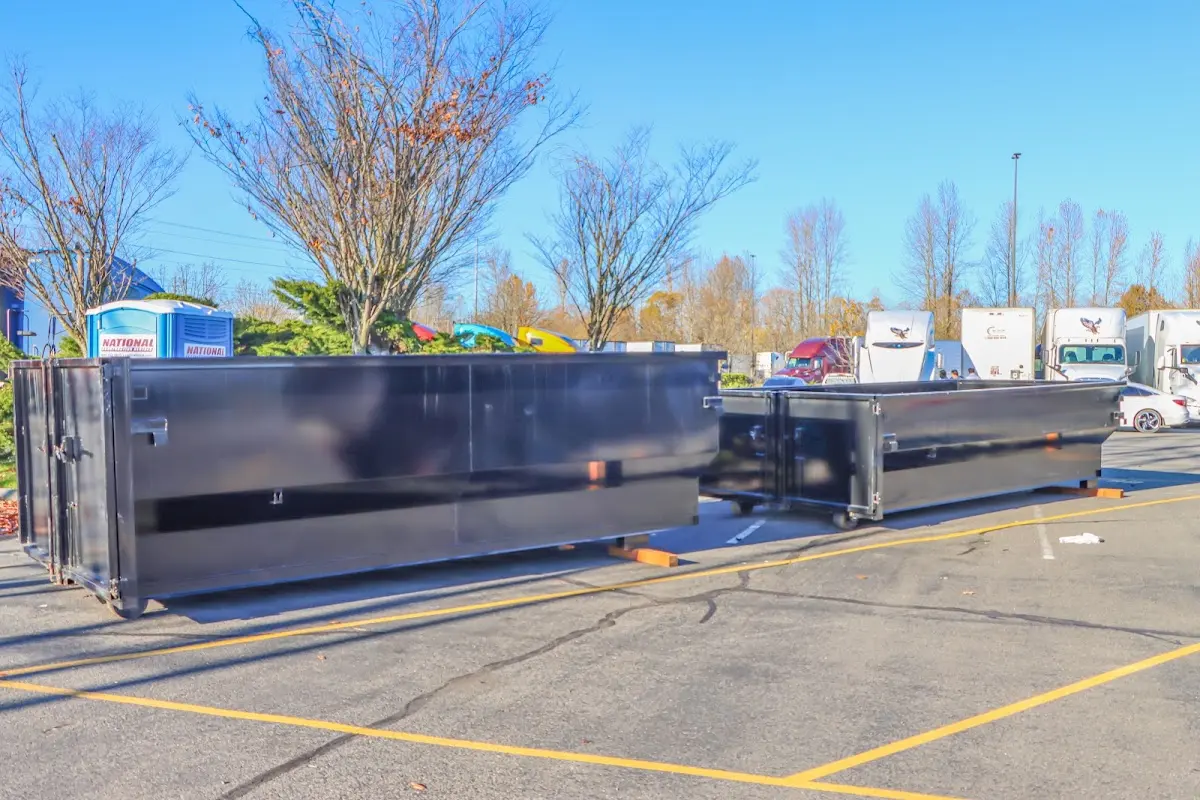 Professional dumpster rental service with roll-off container on residential driveway in Brawley